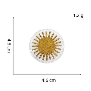 Detail of round sun embroidery patch with dimensions 4.6cm and gold stitch texture