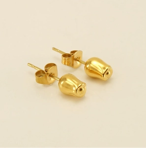 Close-up of polished gold tulip bud stud earrings with butterfly backings