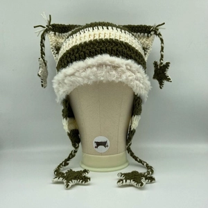 Detail of crochet cat ear hat featuring green stripes and white faux fur trim