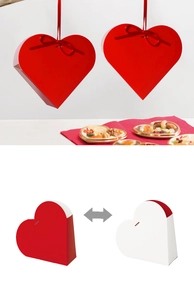 Detail of red and white heart-shaped gift boxes with elegant ribbon bows for Valentine's Day