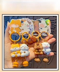 Detail of four cute resin animal keychains featuring shiba inu, cat, pony and cow characters