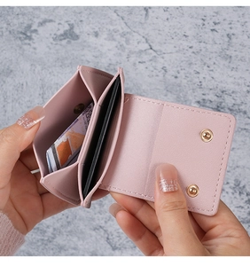 Close-up of the light pink mini wallet interior showing card slots and coin pocket