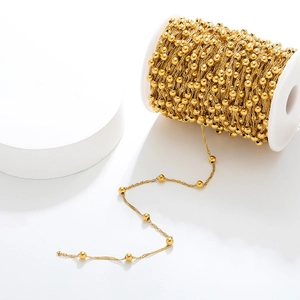Golden stainless steel wave bead chain on a white spool for DIY jewelry making