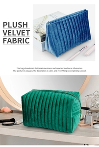 Detail of plush velvet makeup bag with quilted stripes in elegant blue and green colors