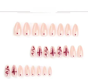 Detail of 24pcs almond press-on nails featuring red snake pattern and cross art designs