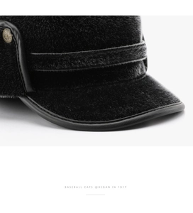 Detail of warm faux fur texture with metal star buckle and leather edge on black winter hat