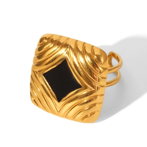 Detailed macro view of 18K gold plated square ring featuring black enamel inlay and texture