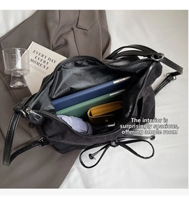 Top view of large black bucket bag interior showing spacious capacity for tablets and books