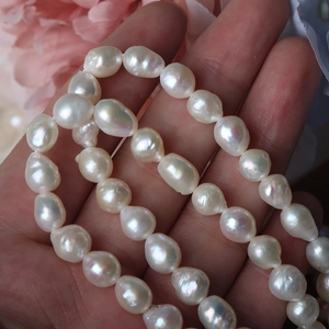 Irregular baroque 6.5-7mm natural freshwater pearls with iridescent luster on hand