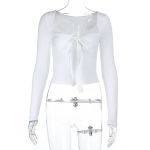 Detail of white long sleeve crop top with lace trim and delicate bow tie neckline