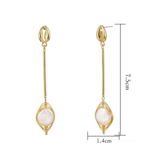 Detail view of gold drop earrings with pearl accents and shell design, 7.5cm x 1.4cm size