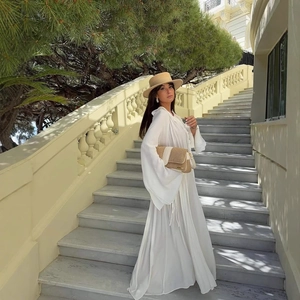 Elegant white V-neck maxi dress with pleated lace and wide brim straw hat for summer vacations
