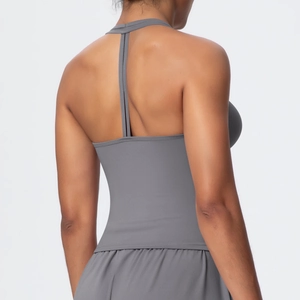 Detail view of grey sports bra featuring thin T-back straps and matte elastic fabric