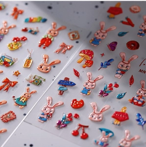 Macro shot of 3D embossed nail stickers featuring pink rabbits, tulips, and mushrooms