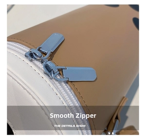 Close-up of smooth double zipper detail on milk tea cup shaped crossbody bag