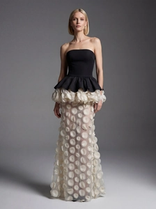 Elegant black and white strapless mermaid gown with layered ruffles and 3D floral petals