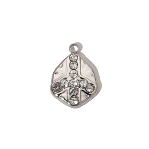 Close-up of diamond-encrusted cross pendant on a silver polished rhombus steel charm