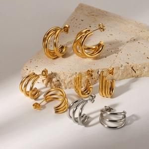 Three-layer C-shaped 18k gold and silver stainless steel hoops on minimalist stone
