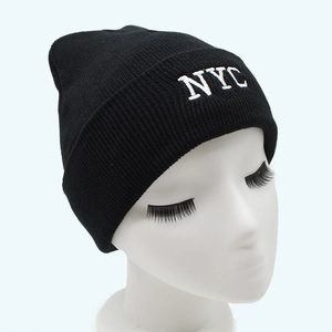 Classic black knit beanie with white NYC embroidery on a cuffed brim for winter