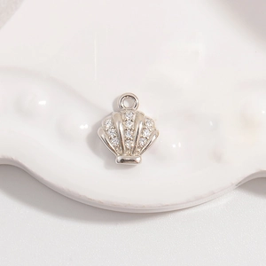 Macro detail of S925 silver seashell pendant with pavé-set shimmering zircon stones