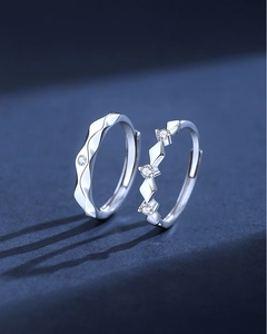 Macro shot of S925 sterling silver couple rings with wavy texture and zircon stones