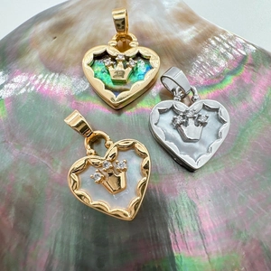 18K gold heart pendants with natural abalone shell and mother of pearl on a shell