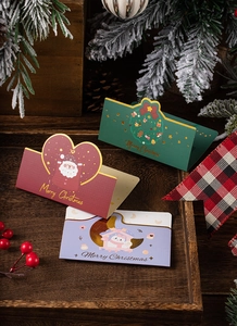 Detailed view of three 3D Christmas cards with wreath, Santa, and penguin designs