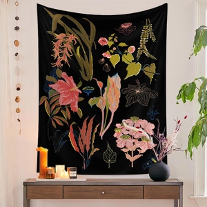 Detail of vintage botanical floral tapestry hanging on wall in a cozy room setting