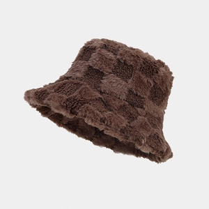 Detailed view of dark brown checkerboard plush texture on a warm bucket hat