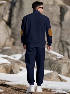 Detail of navy knit tracksuit showing brown elbow patches and back tailoring for men