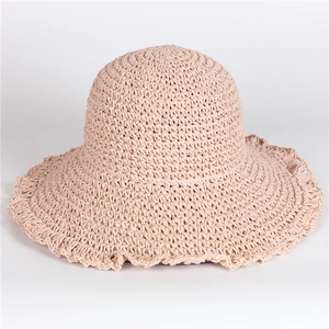 Handwoven wide-brim straw sun hat in soft beige for summer beach sun protection