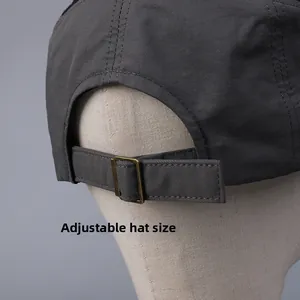 Detail of adjustable brass buckle strap on breathable mesh baseball cap for custom fit