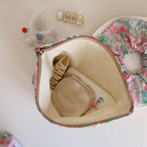 Detail of floral cotton makeup bag interior showing large capacity and zipper closure