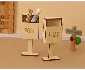 Detailed macro view of miniature wooden dollhouse mailboxes with engraved Post text
