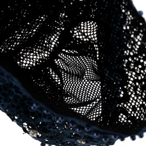 Detail der Spitzen-Turbanmütze mit blauen Perlen und Kristallen auf schwarzem Netz