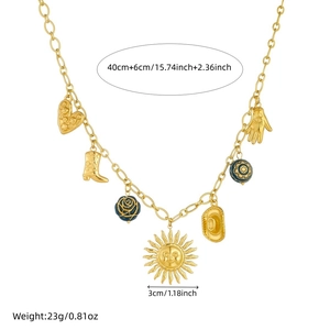 Vintage gold-plated charm necklace with sun, heart, and boot pendants on white background
