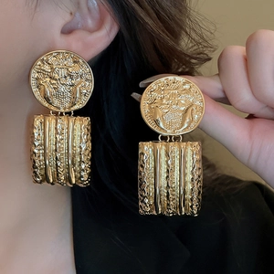 Vintage gold geometric drop earrings featuring round embossed coin and textured rectangle