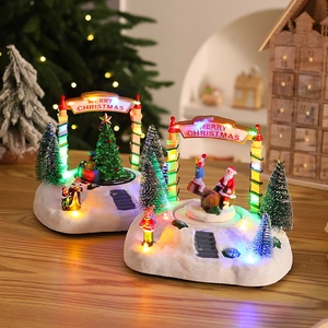 Gros plan d'une boîte à musique maison de Noël en résine avec lumières LED colorées décoratives