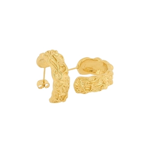 Detailed macro view of gold vintage C-shape earrings with irregular lava texture finish
