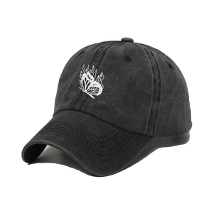 Detail of charcoal washed cotton baseball cap featuring white flame butterfly embroidery