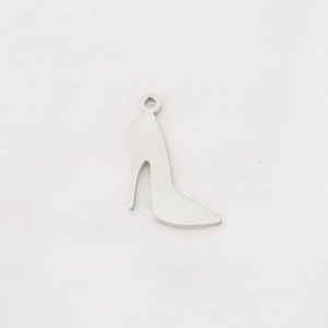 Macro detail of high-heel shaped stainless steel pendant with silver mirror finish