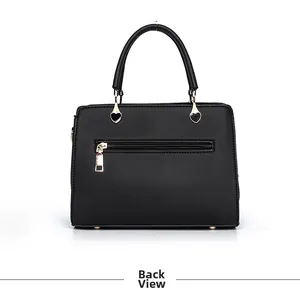 Back view of black faux leather handbag with gold zipper and heart-shaped metal accents