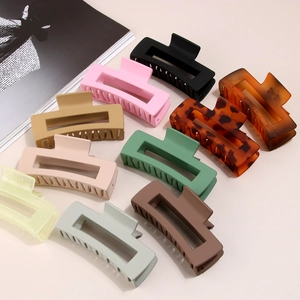Variety of 10.5cm matte and tortoiseshell rectangular hair claws set on neutral background