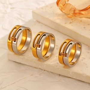Detail of multi-layer mixed color rings with wire wrapping on textured stone