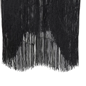 Detailed view of high-quality black velvet tassels on the hem of a stylish party dress
