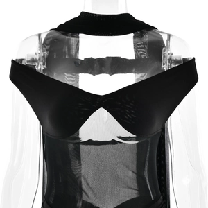 Detail view of black mesh patchwork design with sheer sleeves on a stylish dress