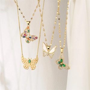 Detail shot of golden butterfly pendant necklaces with colorful zircon and pearl inlays