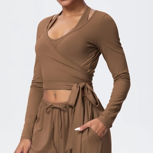 Detail of cross-wrap long sleeve yoga top with waist tie and matching yoga pants