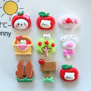 Detail view of 9 cartoon resin charms featuring red apples and cats for DIY crafts