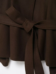 Close-up of the adjustable waist belt and textured wool fabric on this dark brown coat